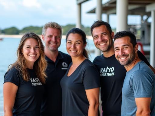 Friendly Kaiyo Aventure Tours team with diving gear, smiling by the Okinawan sea